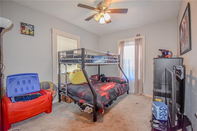 carpeted bedroom with baseboards and ceiling fan