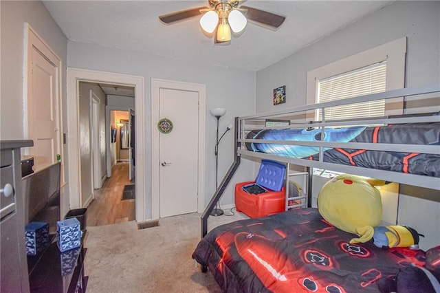 bedroom with a ceiling fan and carpet flooring