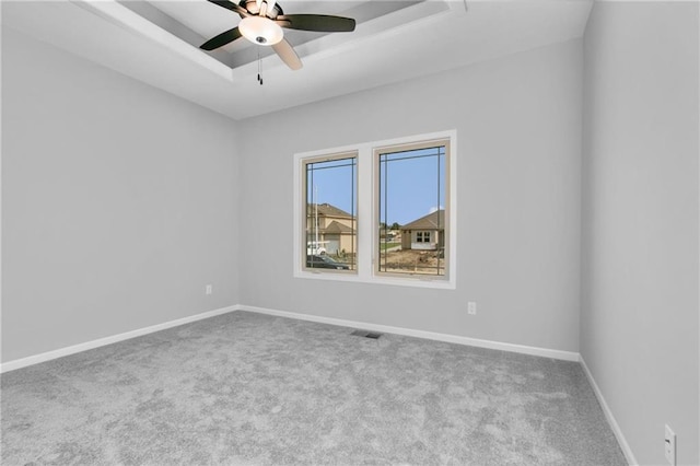 11019 N Bristol Ave, Kansas City, MO 64156 - carpeted empty room with visible vents, baseboards, a raised ceiling, and a ceiling fan