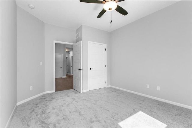 11019 N Bristol Ave, Kansas City, MO 64156 - unfurnished bedroom with carpet floors, baseboards, visible vents, and a ceiling fan