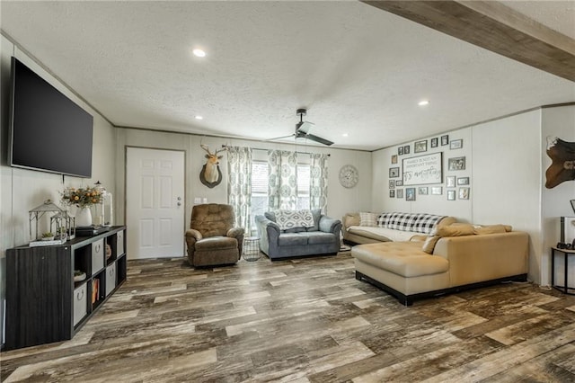 living room featuring a textured ceiling, ceiling fan, wood finished floors, and recessed lighting