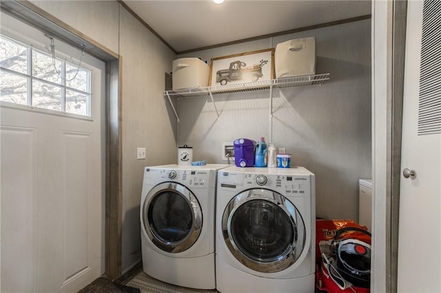 clothes washing area featuring laundry area and separate washer and dryer