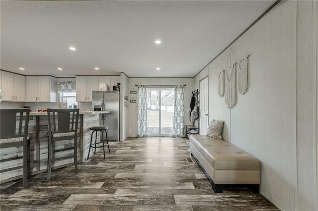 interior space with recessed lighting, wood finished floors, and a healthy amount of sunlight