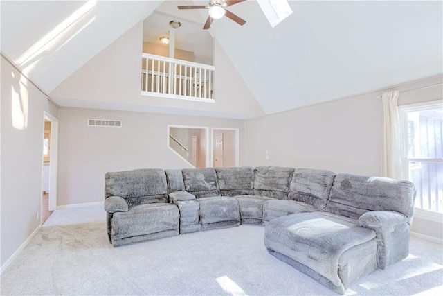 living room featuring carpet flooring, a ceiling fan, visible vents, baseboards, and stairway