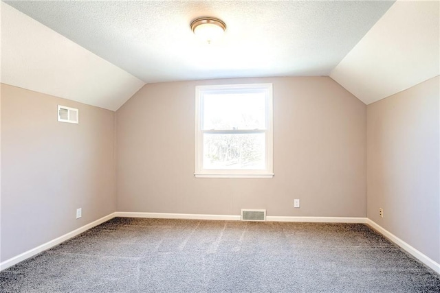 bonus room featuring visible vents, a textured ceiling, and carpet flooring