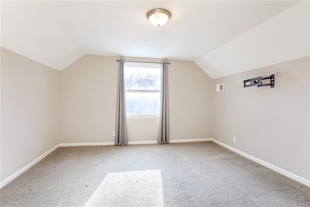 bonus room with vaulted ceiling, carpet flooring, and baseboards