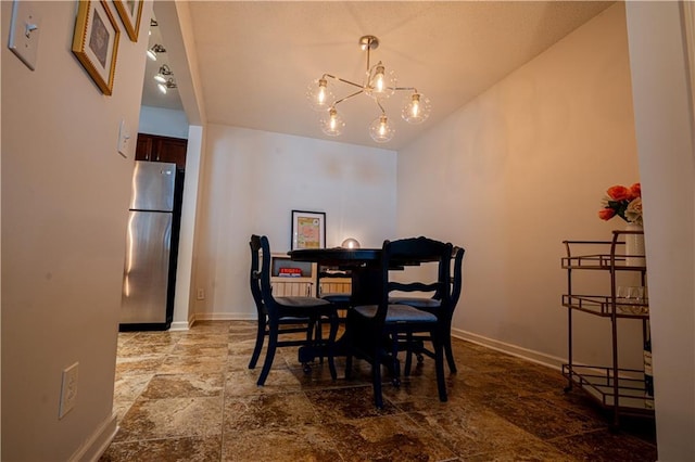 dining area featuring baseboards, vaulted ceiling, stone finish floor, and a notable chandelier