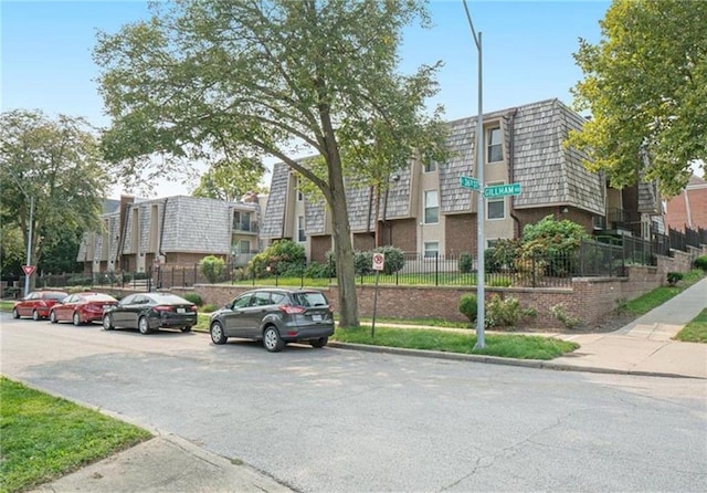 view of property featuring a residential view and fence