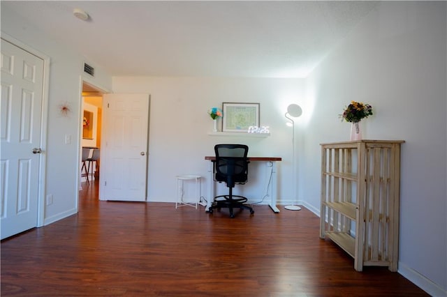 home office featuring wood finished floors, visible vents, and baseboards