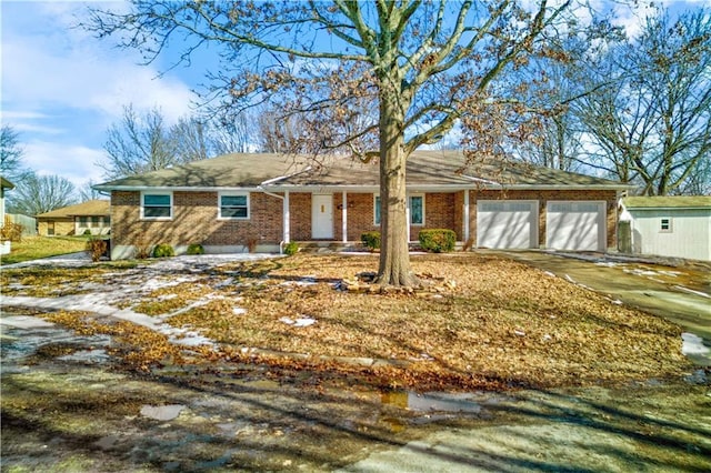 ranch-style home with brick siding, driveway, and an attached garage