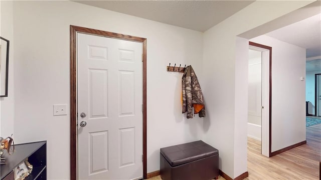 interior space featuring light wood-type flooring and baseboards