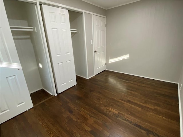 unfurnished bedroom featuring a closet and dark wood finished floors