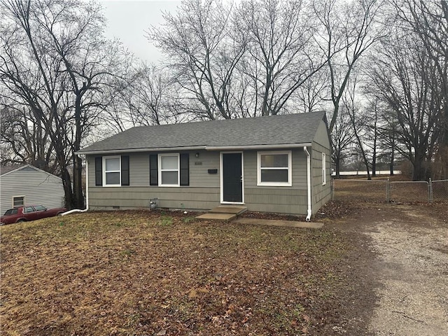 view of front of property with entry steps, roof with shingles, crawl space, a gate, and fence