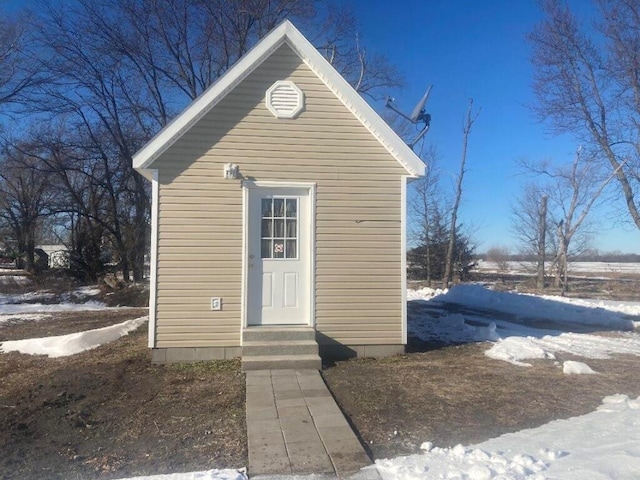 snow covered structure with entry steps
