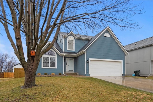 view of front facade with a garage, driveway, a front yard, and fence