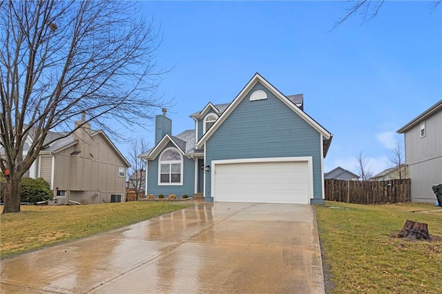 traditional-style home featuring a garage, driveway, a front lawn, and fence