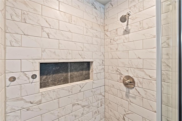 bathroom with a fireplace and a tile shower