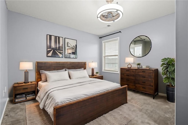 bedroom featuring baseboards and light colored carpet