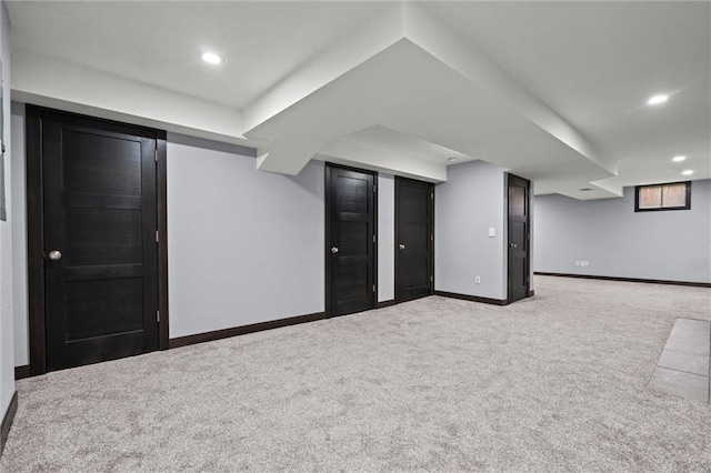 finished basement featuring carpet floors, baseboards, and recessed lighting