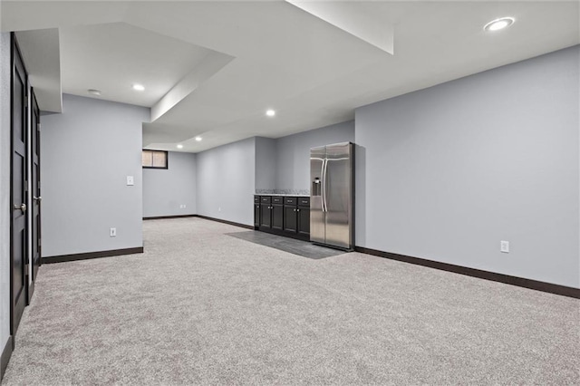 interior space featuring baseboards, recessed lighting, stainless steel fridge, and light colored carpet