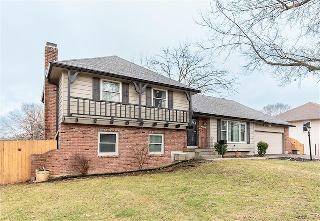 tri-level home featuring a front lawn, brick siding, and a chimney