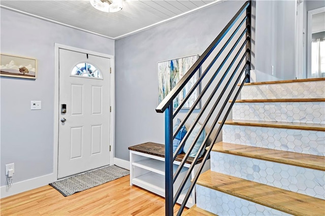 entrance foyer featuring stairway, wood finished floors, and baseboards