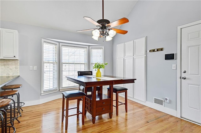 dining space featuring visible vents, baseboards, ceiling fan, and light wood finished floors