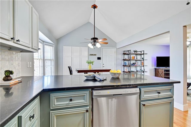 kitchen with light wood-type flooring, tasteful backsplash, a peninsula, dishwasher, and vaulted ceiling