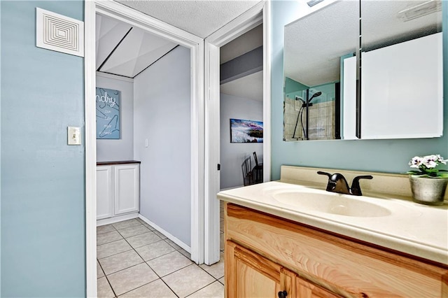 bathroom featuring visible vents, a textured ceiling, vanity, and tile patterned flooring