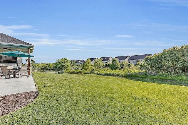 view of yard featuring fence and a patio