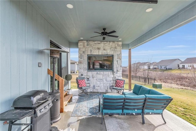 view of patio with a grill, fence, outdoor lounge area, and a ceiling fan