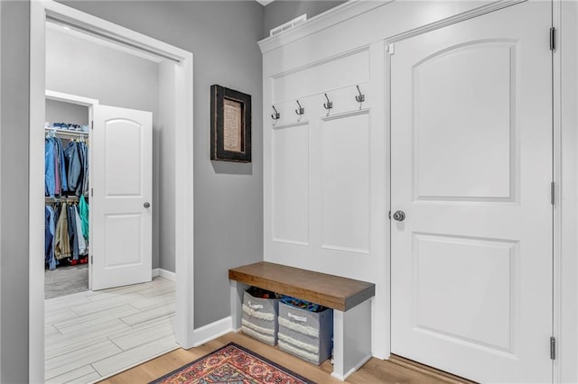 mudroom featuring light wood-style floors and baseboards