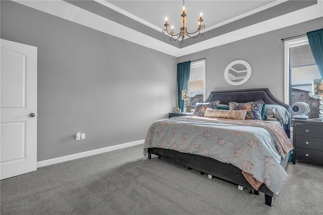 bedroom featuring carpet, baseboards, a raised ceiling, and a notable chandelier