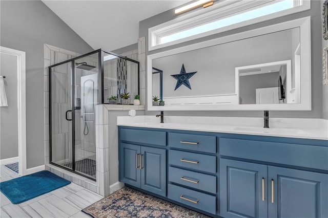 full bath with vaulted ceiling, double vanity, a sink, and a shower stall