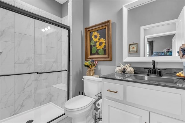 bathroom featuring a stall shower, vanity, and toilet