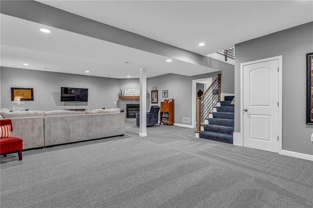 carpeted living area with baseboards, stairway, and recessed lighting