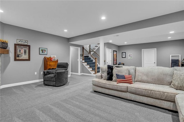 carpeted living room with stairs, baseboards, and recessed lighting