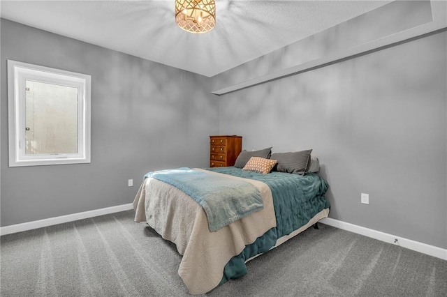 bedroom featuring baseboards and carpet flooring