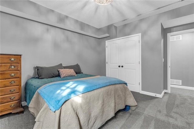 bedroom featuring carpet floors, a closet, visible vents, and baseboards