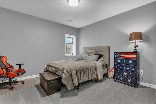 carpeted bedroom with baseboards, visible vents, and a textured ceiling