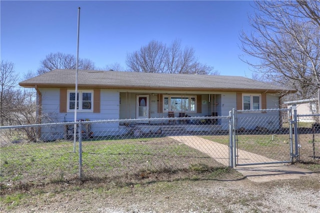 view of front of home with covered porch, a fenced front yard, and a gate