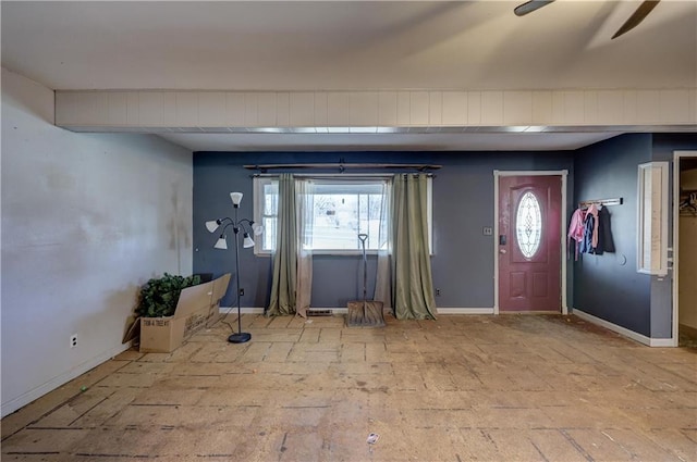 foyer featuring a healthy amount of sunlight and baseboards