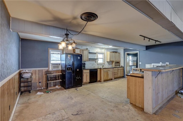 kitchen with wooden walls, a wainscoted wall, a breakfast bar, black appliances, and track lighting