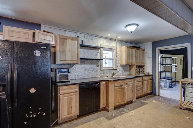 kitchen featuring a sink, light brown cabinetry, black appliances, tasteful backsplash, and dark countertops