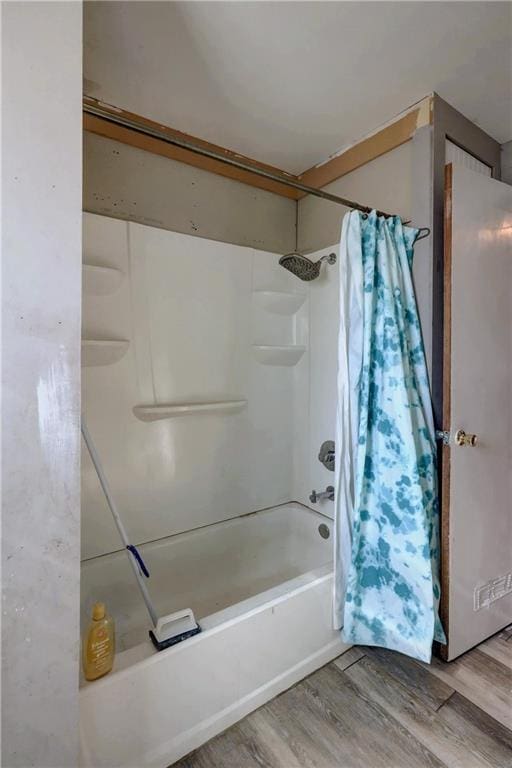 full bath featuring shower / tub combo and wood finished floors