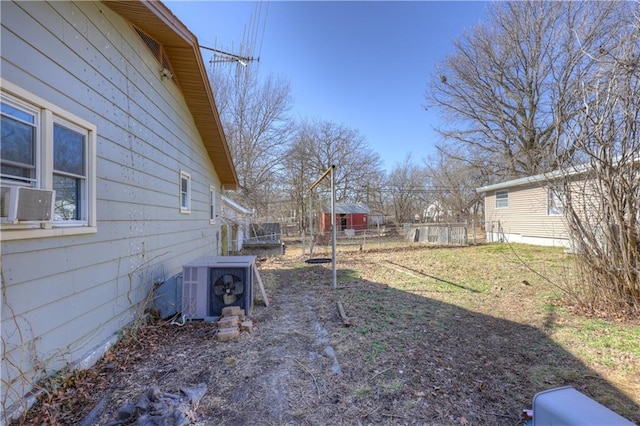 view of yard featuring central AC unit and fence