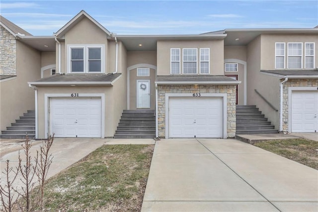 multi unit property featuring concrete driveway, an attached garage, stone siding, and stucco siding