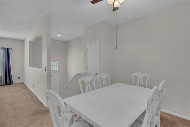 dining room with a ceiling fan, baseboards, and carpet floors