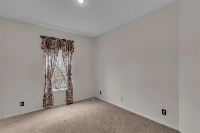 unfurnished room with baseboards and carpet floors