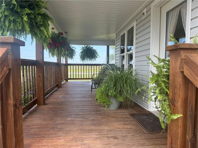 wooden terrace featuring covered porch